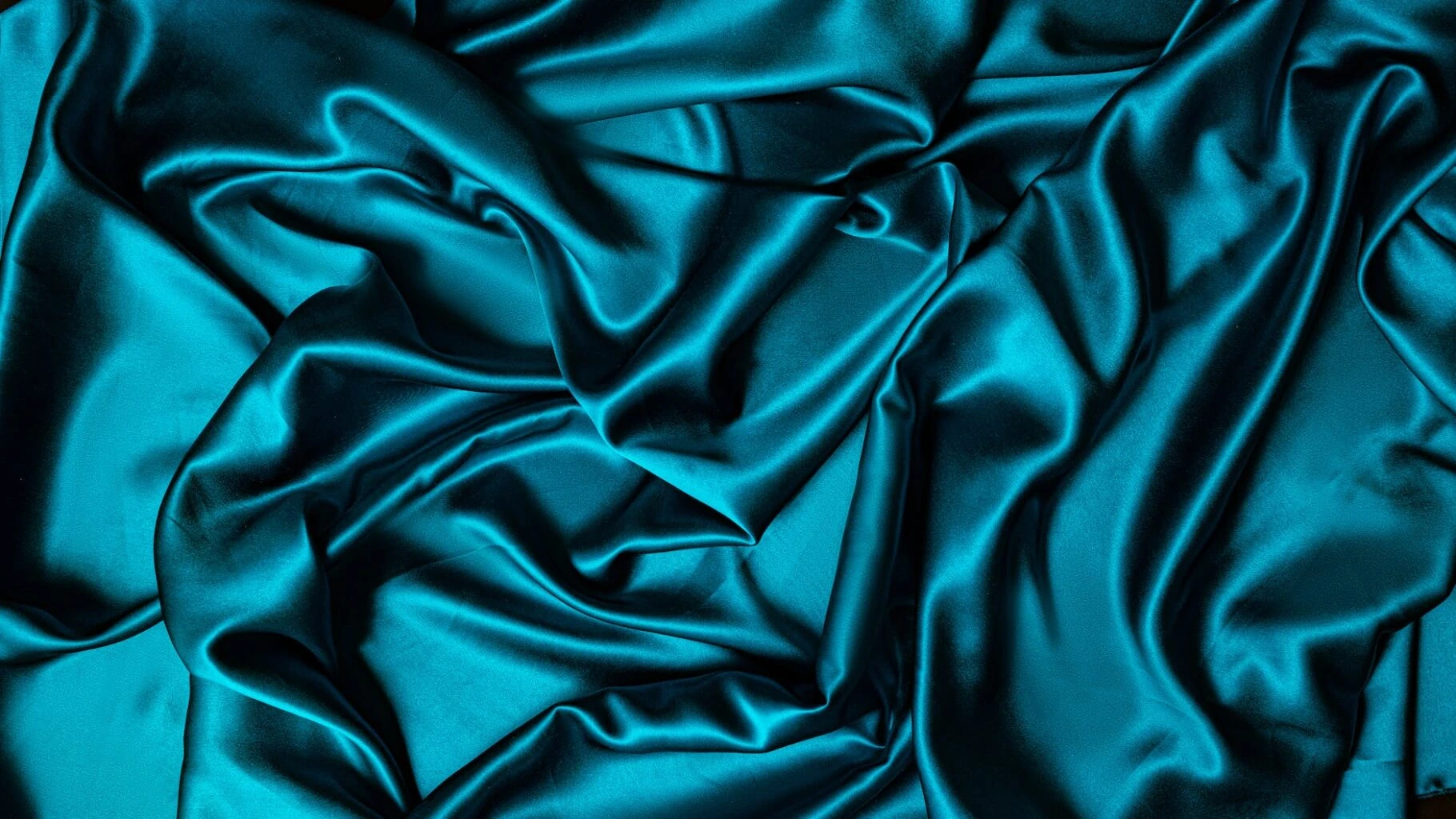 teal textile on flat surface