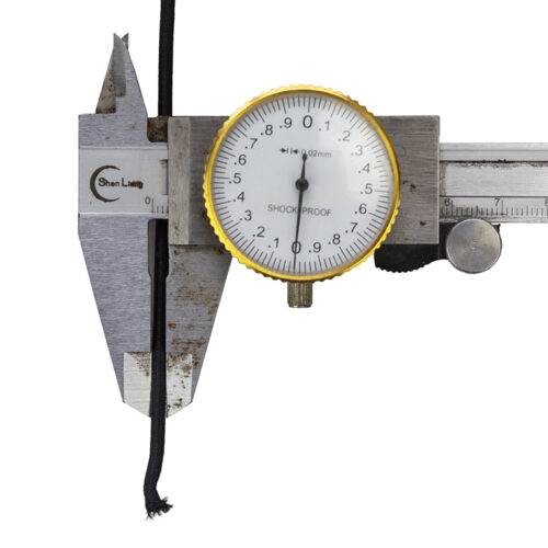 An elastic cord being measured with a caliper.