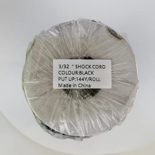 Packaged black elastic cord with product label close-up.