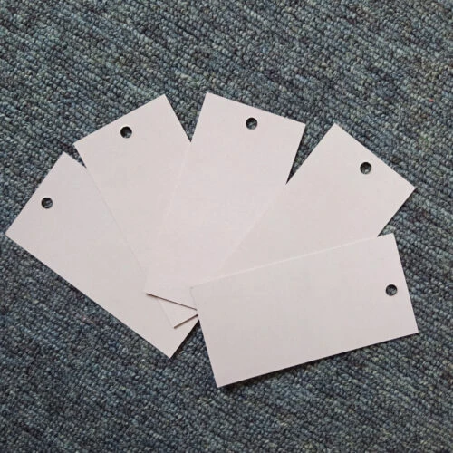 A photo showcasing a custom clothing hang tag. The hang tag features the brand name, logo, and other customized information.