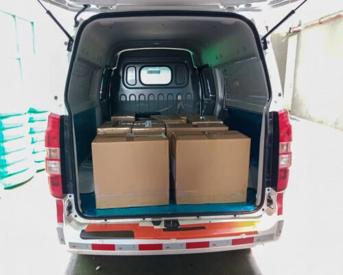This picture showcases boxes filled with bows loaded in a vehicle, preparing for delivery to customers. This image demonstrates our commitment and preparation for the safe transportation of the products.