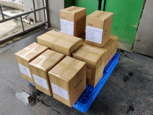 Fully packed boxes of elastic cord and other products on a trailer.