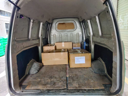 Packed boxes of elastic cord and other products on a truck.