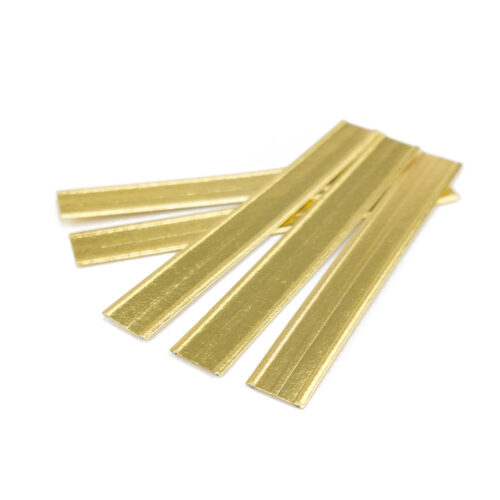 Several scattered gold double wire twist ties.