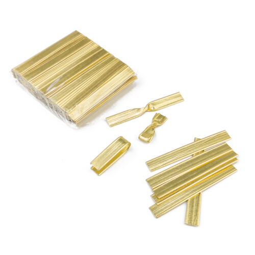 One pack of gold double wire twist ties, some used ones, and several scattered ones.