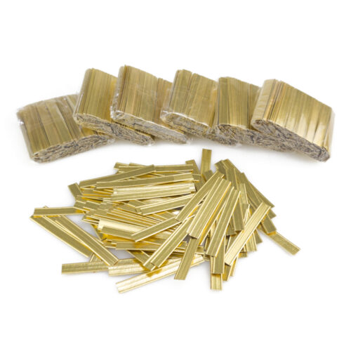 A pile of gold double wire twist ties with several packs in the background.