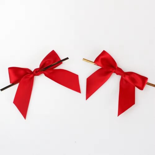 Two vibrant red ribbon bows with twist ties, ideal for gift wrapping and decorations.