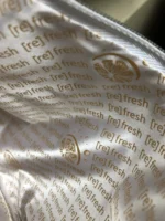 Close-up view of a white ziplock bag with “refresh” text and citrus fruit slice pattern.
