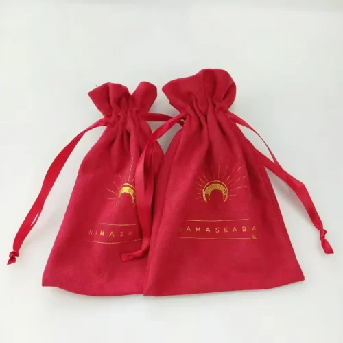 Dos bolsas de regalo personalizadas con cordón rojo con impresión dorada sobre fondo blanco.