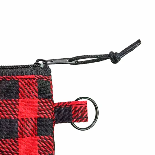 Custom zippered pouch with leather patch, showcasing a colorful design and a keyring attachment.