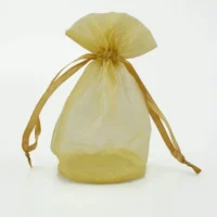 Custom round bottom organza bag in gold color with drawstring closure, showcasing its unique shape and design.
