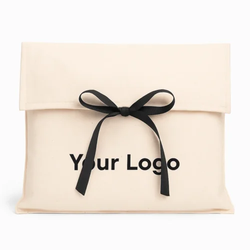 Front-view sample of a cream custom fold over pouch with ribbon tie on a white background.