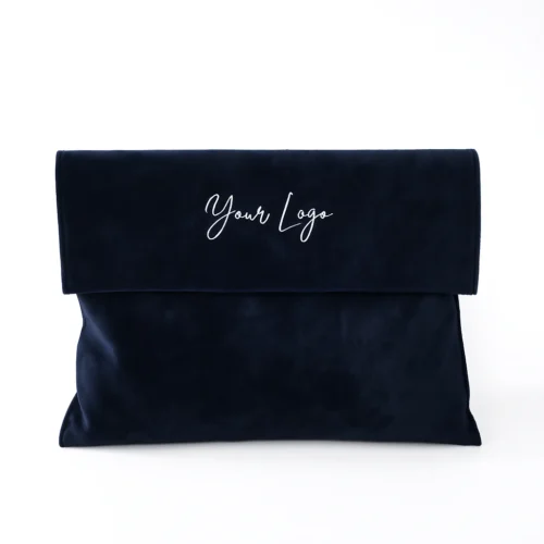 Pochette à rabat en velours bleu marine profond avec pli enveloppe élégant, personnalisable avec un logo.