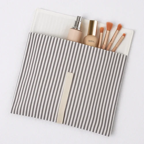 Open custom fold over pouch sample showing striped exterior and lined interior with product storage