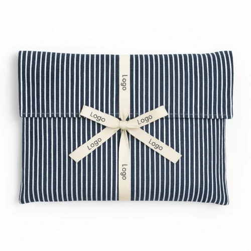 Navy striped custom fold over pouch sample with a cream ribbon bow, showing pattern and ribbon customization.