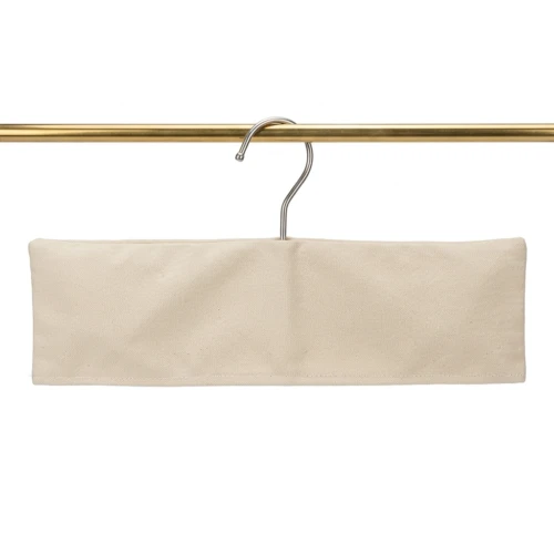 Beige canvas Custom Fabric Hanger Covers in a straight trouser bar cut, front view on a gold rail