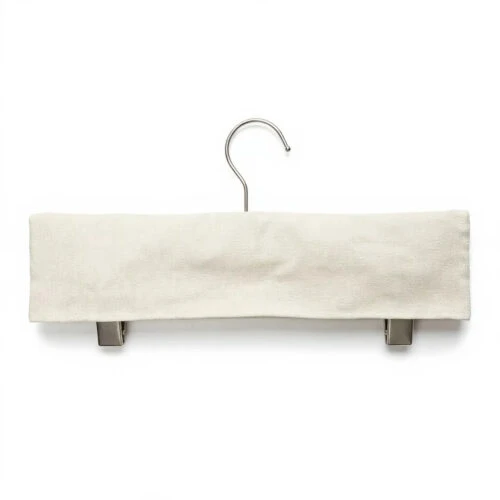 Custom Fabric Hanger Covers in natural cotton fitted over a metal clamp hanger with two exposed clips