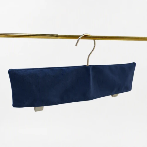Navy trouser bar Custom Fabric Hanger Covers for clamp hangers, hanging on a gold rail