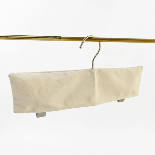Off-white trouser bar Custom Fabric Hanger Covers with skirt clips visible below the sleeve