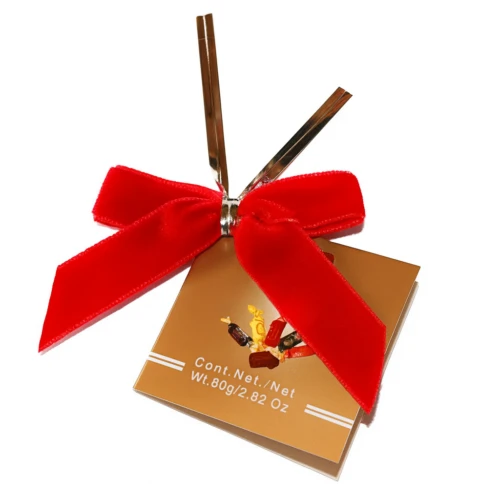 Red velvet ribbon bows with a metallic twist tie fastened to a custom gift box, wholesale packaging sample